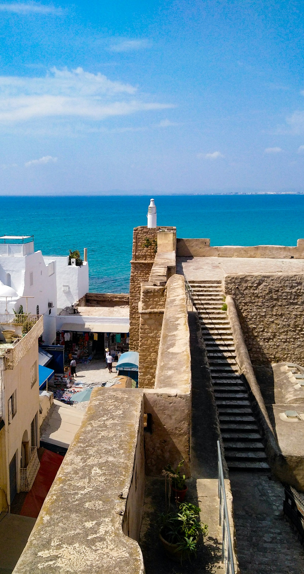 The medina walls and lighthouse of Hammamet with the turquoise Mediterranean sea, at the entrance to the Cap Bon peninsula, Tunisia