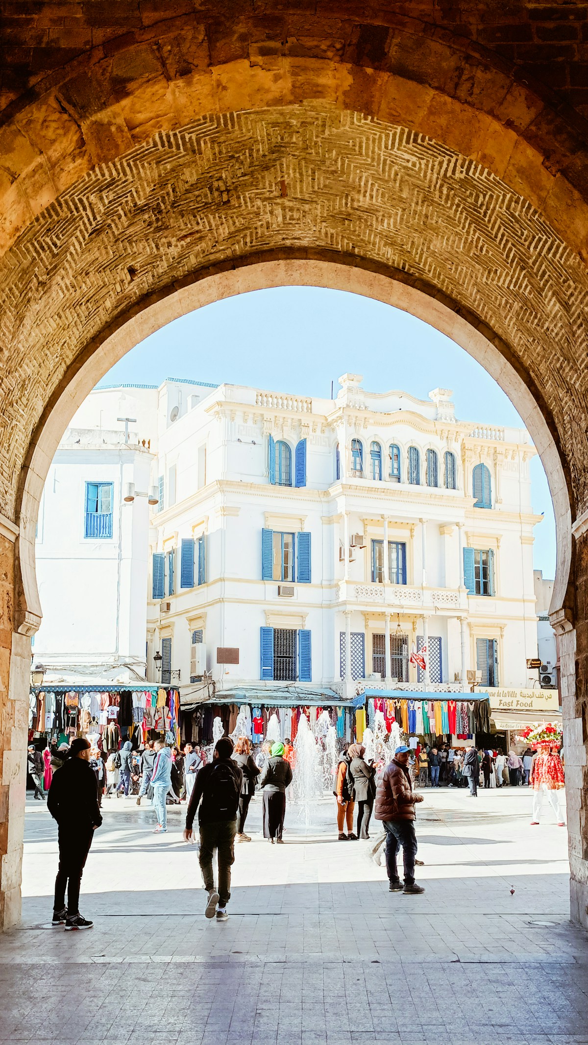 People walking through Bab El Bhar, the sea gate into the Tunis medina, Tunisia