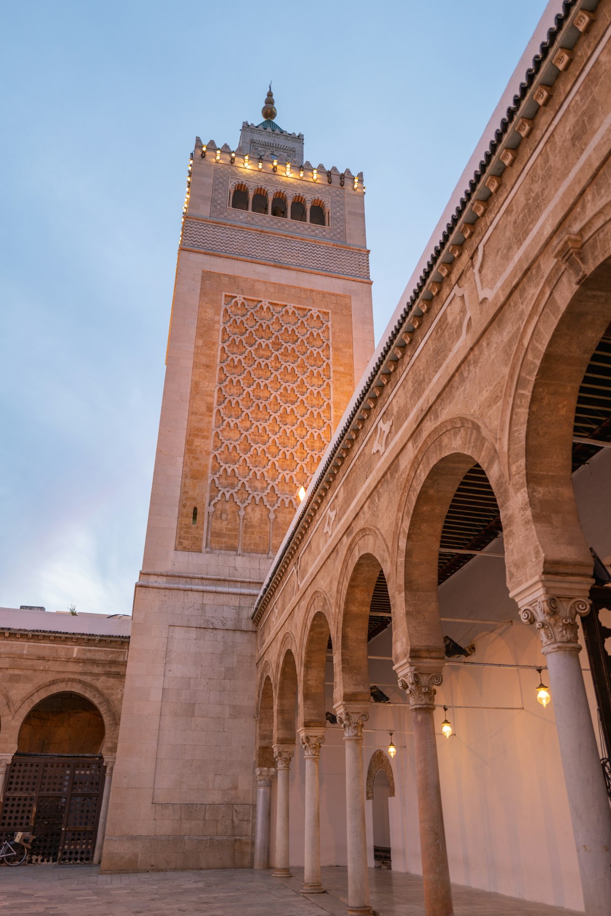 The illuminated minaret of the Zitouna Mosque rising above the medina of Tunis, Tunisia